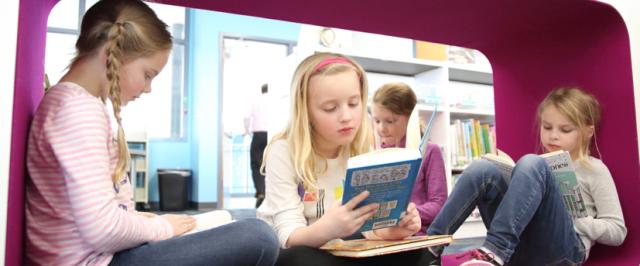 Girls reading in cube