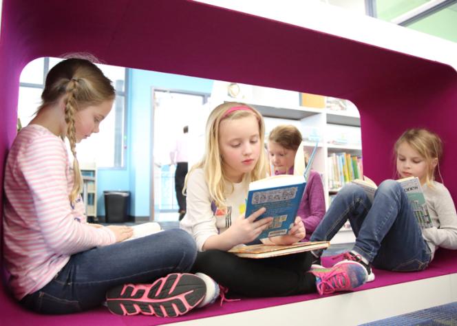 Girls reading in cube